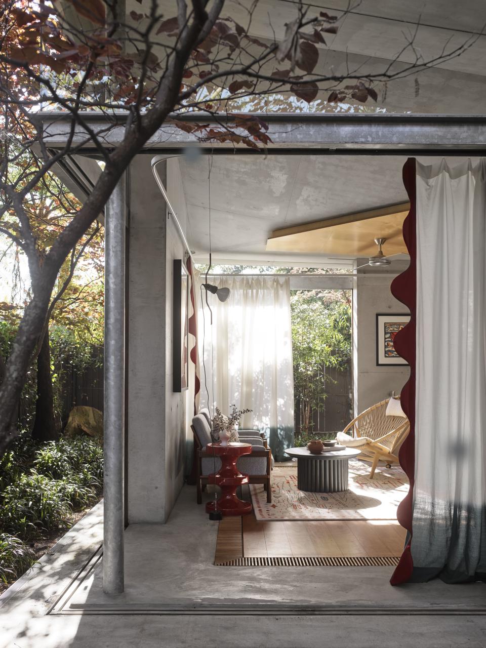 Modern living rom with white curtains with red border