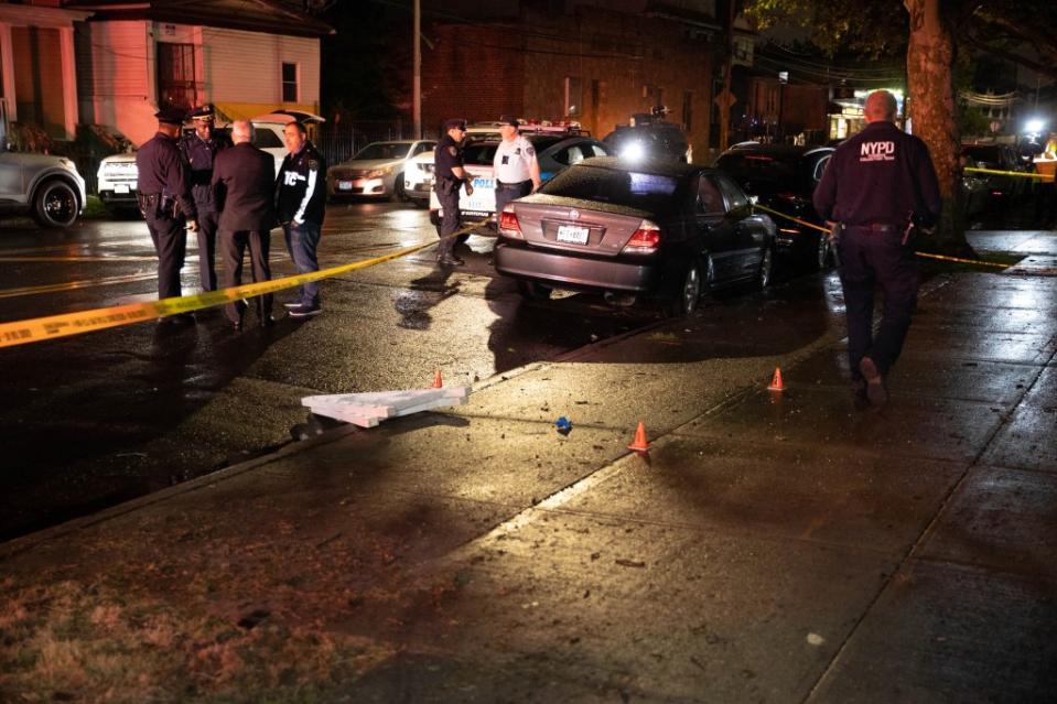 Police are seen at the scene of a shooting at 106-22 160 St. in Queens, Wednesday. Robert Mecea