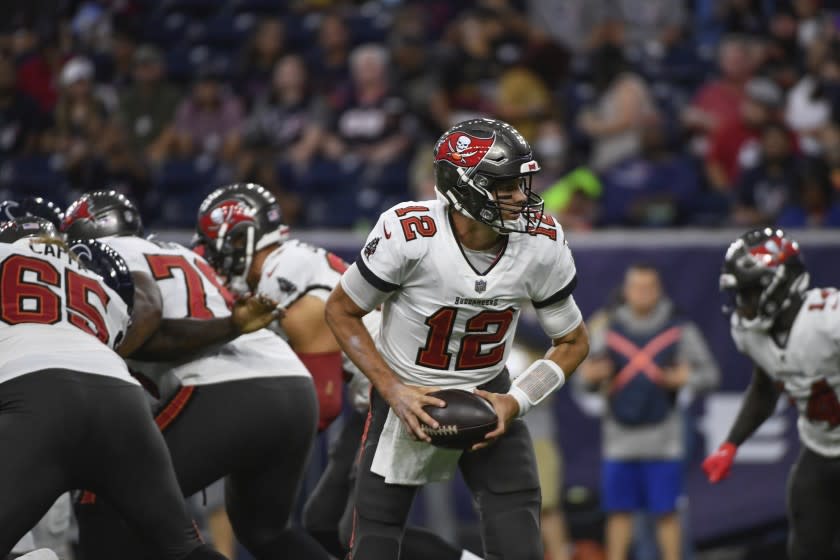 Tampa Bay Buccaneers quarterback Tom Brady (12) hands off the ball against the Houston Texans.