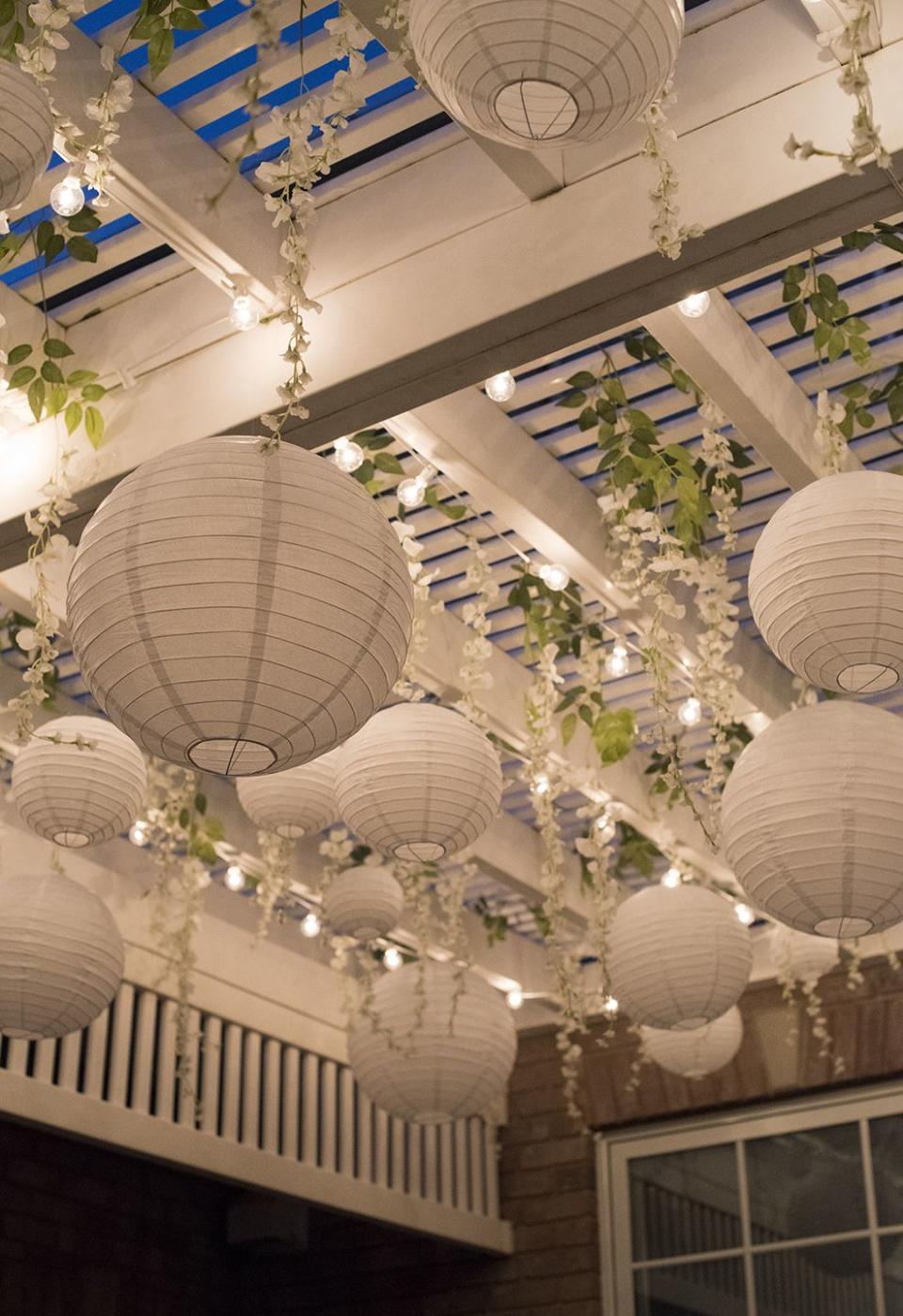 paper lanterns and fairy lights on a pergola