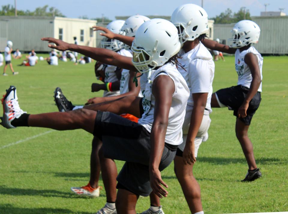 Mandarin High School football players stretch during practice on Aug. 1.