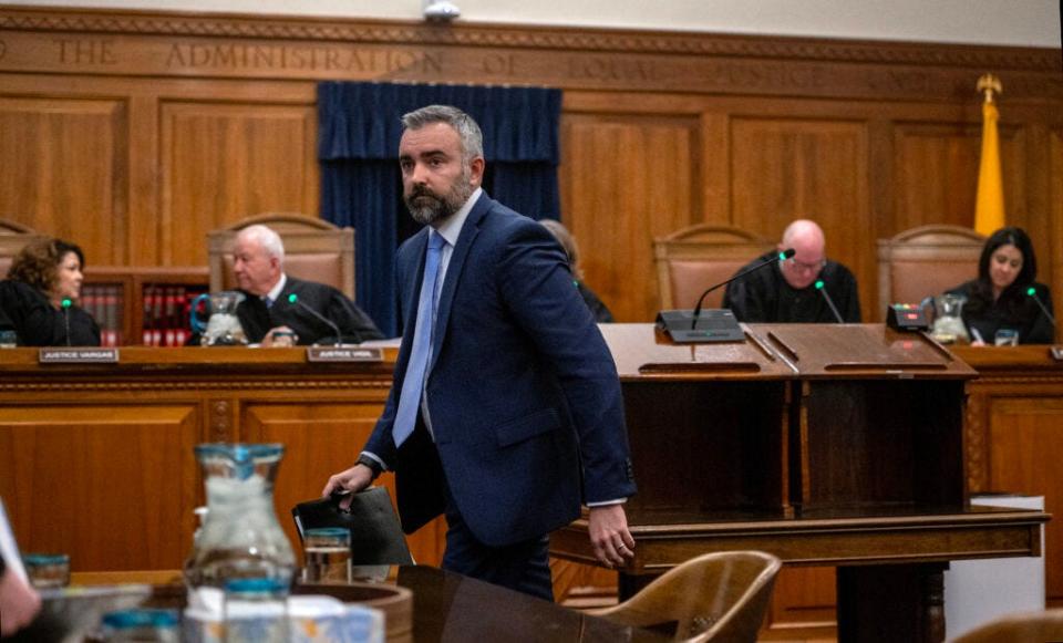 New Mexico Attorney General Raul Torrez returns to his seat after making an oral argument against local municipalities implementing ordinances restricting abortion rights. This is during a New Mexico Supreme Court hearing, being held in Santa Fe Wednesday, December 13, 2023.