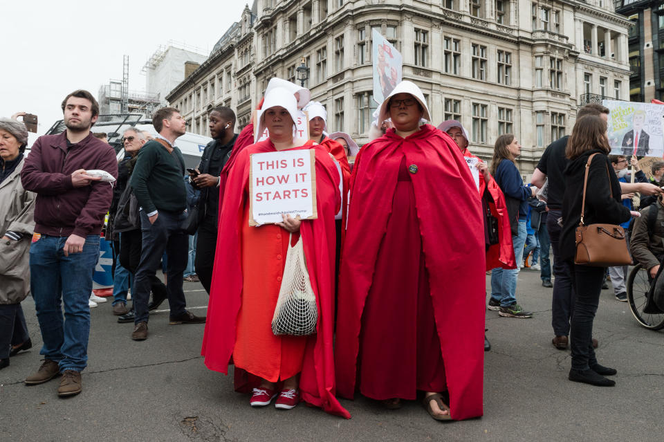 LONDON, UNITED KINGDOM - JUNE 04: Protesters dressed as handmaids take part in Together Against Trump march to Parliament Square on the second day of the US President's three-day state visit to the United Kingdom on 04 June, 2019 in London, England. (Photo credit should read Wiktor Szymanowicz / Barcroft Media via Getty Images)