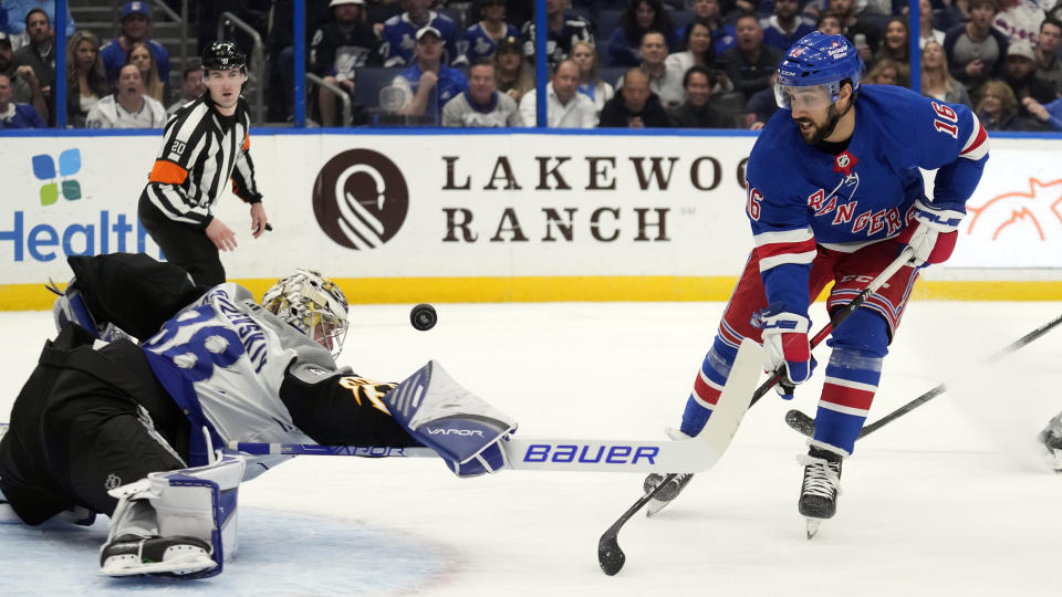 Tampa Bay Lightning goaltender Andrei Vasilevskiy (88) knocks the puck away from New York Rangers center Vincent Trocheck (16) during the first period of an NHL hockey game Thursday, Dec. 29, 2022, in Tampa, Fla. (AP Photo/Chris O'Meara)