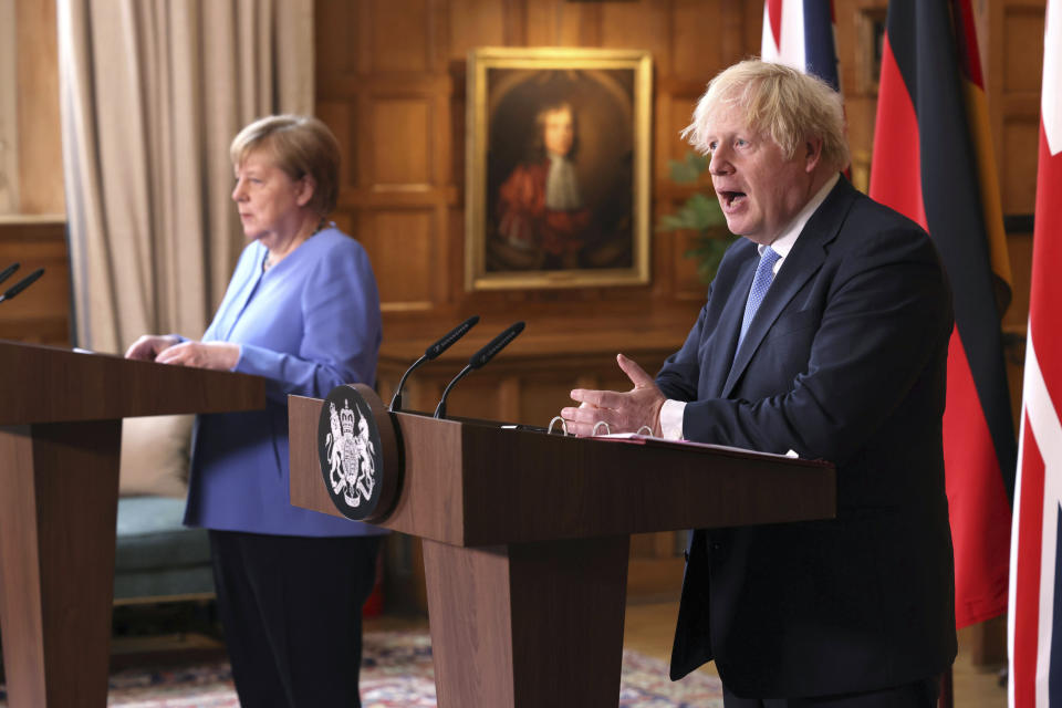 Britain's Prime Minister Boris Johnson, right and German Chancellor Angela Merkel, take part in a press conference after their meeting at Chequers, the country house of the Prime Minister, in Buckinghamshire, England, Friday July 2, 2021. Johnson is likely to push Angela Merkel to drop her efforts to impose COVID-19 restrictions on British travelers as the German chancellor makes her final visit to Britain before stepping down in the coming months. Johnson will hold talks with Merkel at his country residence on Friday. (Jonathan Buckmaster//Pool Photo via AP)