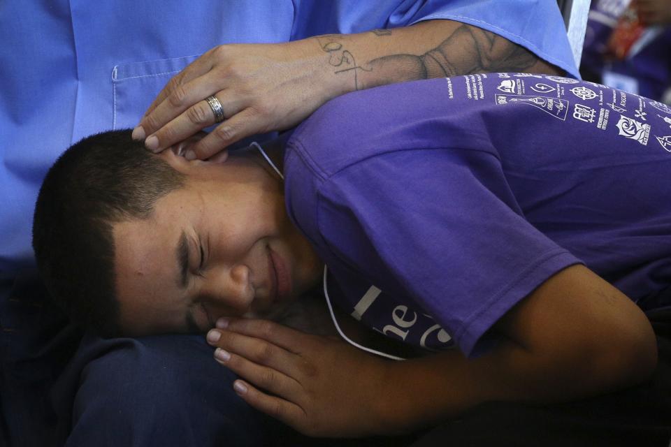 Richard Feliz comforts his son during a "Get On the Bus" visiting day to Folsom State Prison