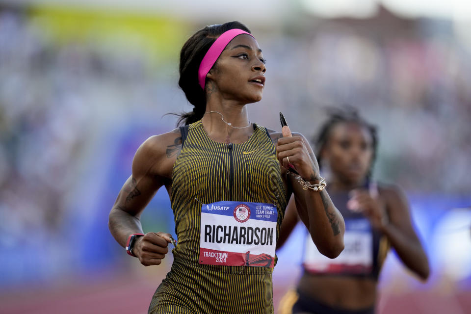 Sha'Carri Richardson wins a heat women's 100-meter run during the U.S. Track and Field Olympic Team Trials Friday, June 21, 2024, in Eugene, Ore. (AP Photo/Charlie Neibergall)