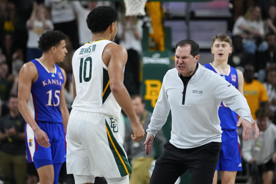 Baylor head coach Scott Drew, right, reacts with RayJ Dennis (10) during the second half of an NCAA college basketball game against Kansas, Saturday, March 2, 2024, in Waco, Texas. Baylor won 82-74. (AP Photo/Julio Cortez)