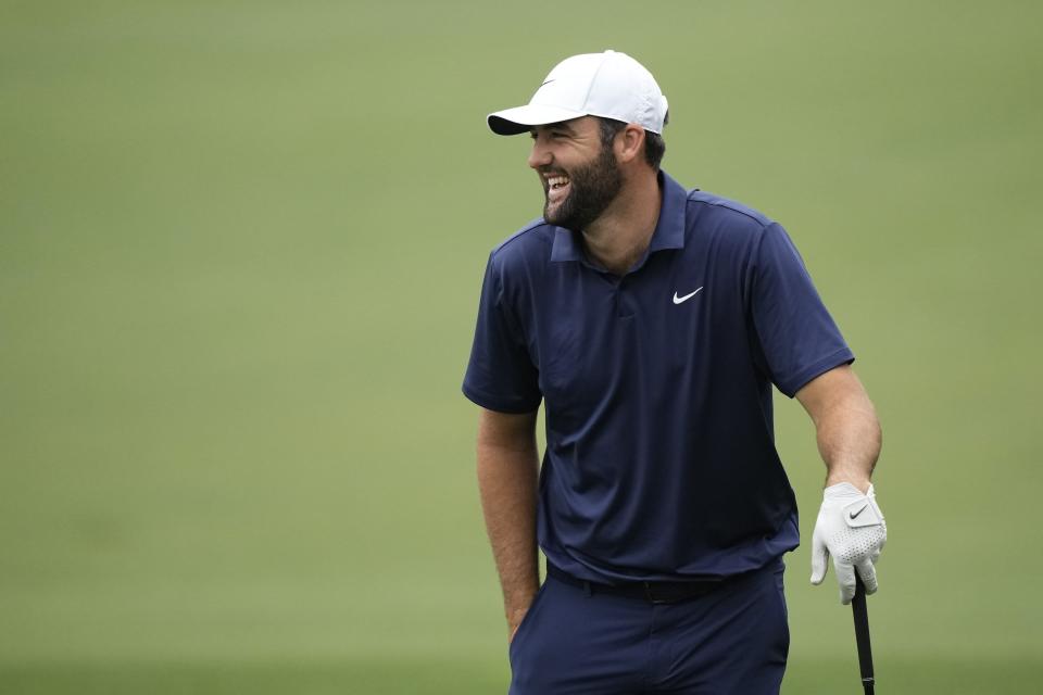 Scottie Scheffler laughs on the driving range during a practice round in preparation for the Masters golf tournament at Augusta National Golf Club Tuesday, April 9, 2024, in Augusta, Ga. (AP Photo/Charlie Riedel)