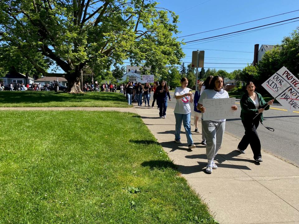 Students on Friday walk out of North Salem High School and march to the Student Support Services Center.