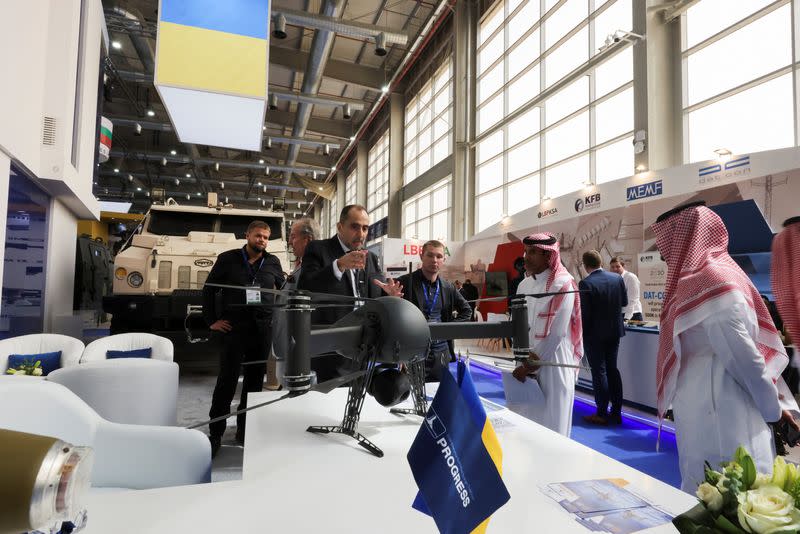 A salesman explains to visitors about its military defense systems at Ukrainian stand displaying the latest defense system at World Defense Show in Riyadh, Saudi Arabia