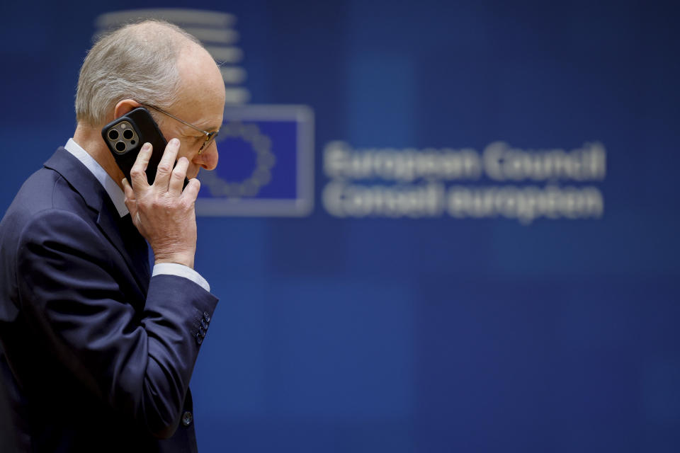 Luxembourg's Prime Minister Luc Frieden talks on his cell phone during a round table meeting at an EU summit in Brussels, Thursday, Feb. 1, 2024. European Union leaders meet in Brussels for a one day summit to discuss the revision of the Multiannual Financial Framework 2021-2027, including support for Ukraine. (AP Photo/Geert Vanden Wijngaert)
