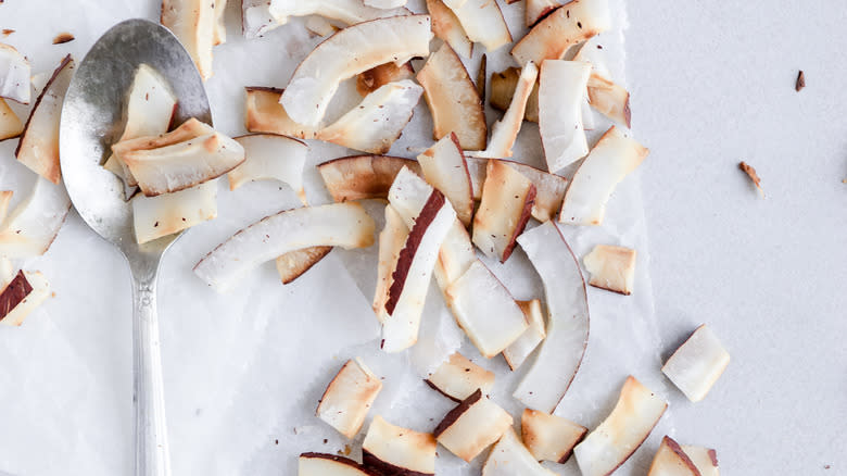 Strips of toasted coconuts and a spoon