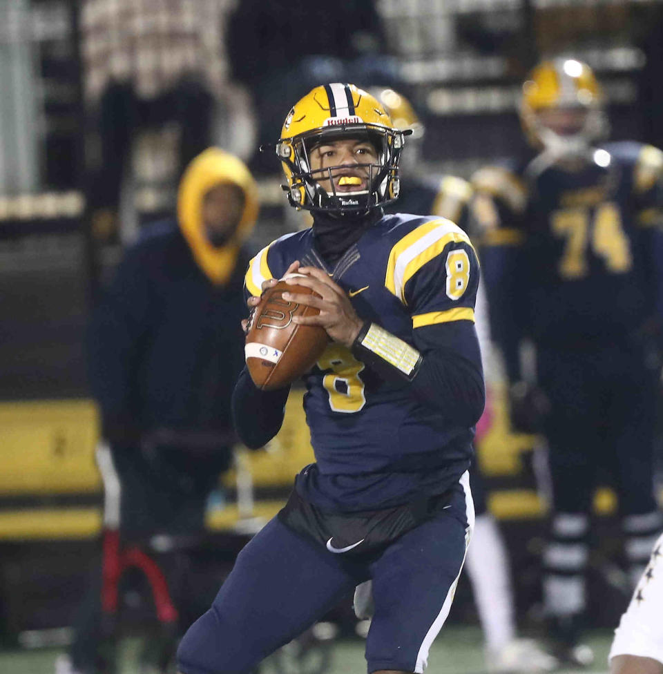 Springfield quarterback Te'Sean Smoots drops back to pass during their 22-21 win over Moeller, Friday, Nov. 26, 2021.