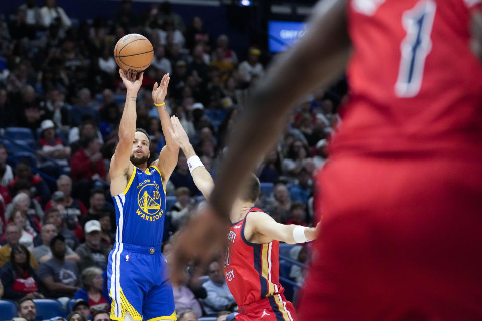 Golden State Warriors guard Stephen Curry (30) shoots a 3-point shot in the first half of an NBA basketball game against the New Orleans Pelicans in New Orleans, Monday, Oct. 30, 2023. (AP Photo/Gerald Herbert)