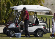 Tiger Woods takes a drink during a training session at the Albany Golf Club, in New Providence, Bahamas, Sunday, Dec. 5, 2021.(AP Photo/Fernando Llano)