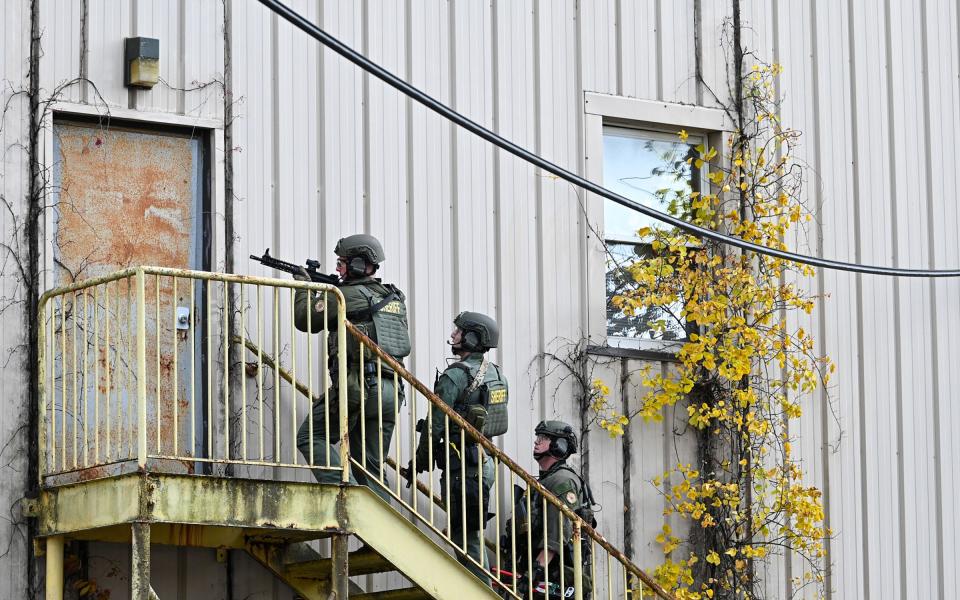 Frederick County Sheriff's SWAT Team members prepare to search a vacant building at the former Garden State Tannery plant near Williamsport on Saturday after murder suspect Pedro Argote's SUV was found in the area. Argote is the suspect in the murder of Washington County Circuit Court Judge Andrew Wilkinson.