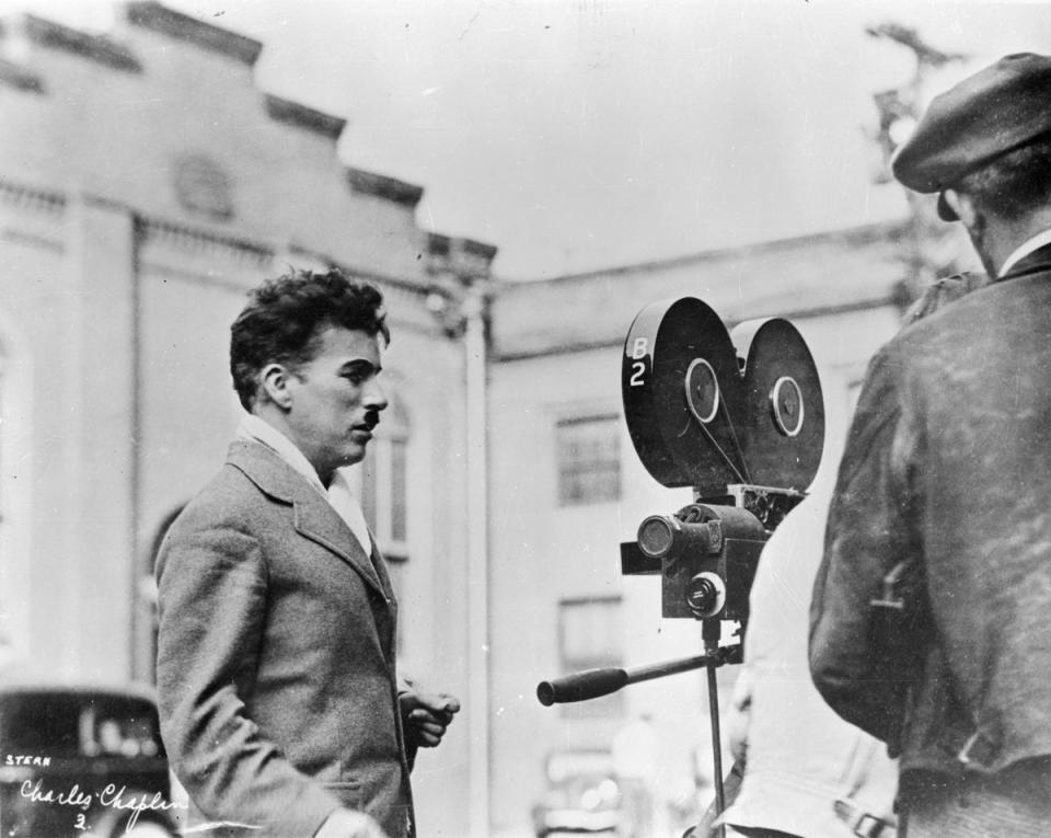 Charlie Chaplin looking at a movie camera (Keystone/Getty Images)