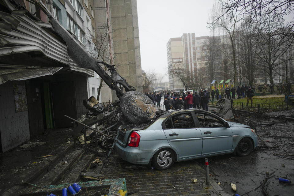 A view of the scene where a helicopter crashed on civil infrastructure in Brovary, on the outskirts of Kyiv, Ukraine, Wednesday, Jan. 18, 2023. The chief of Ukraine's National Police says a helicopter crash in a Kyiv suburb has killed 16 people, including Ukraine's interior minister and two children. He said nine of those killed were aboard the emergency services helicopter. (AP Photo/Daniel Cole)