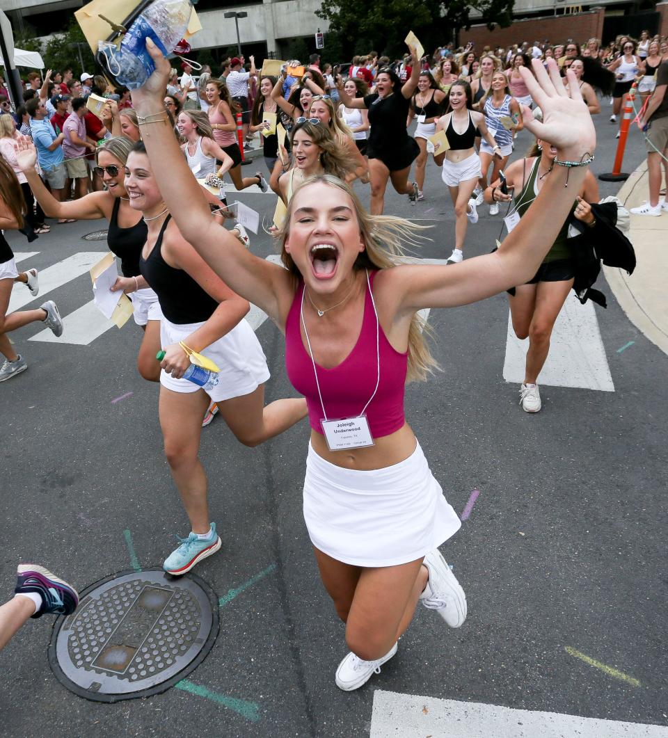 New sorority sisters run to their houses along sorority row after receiving their bids inside Bryant-Denny Stadium Sunday, Aug. 15, 2021.[Staff Photo/Gary Cosby Jr.]