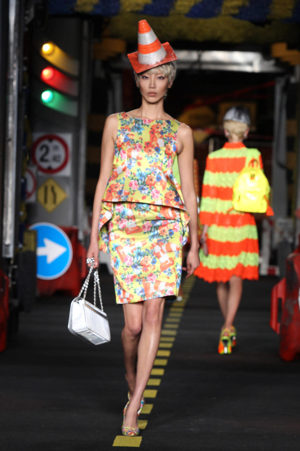 A model wears a floral and pylon-print dress on Moschino’s spring 2016 runway.