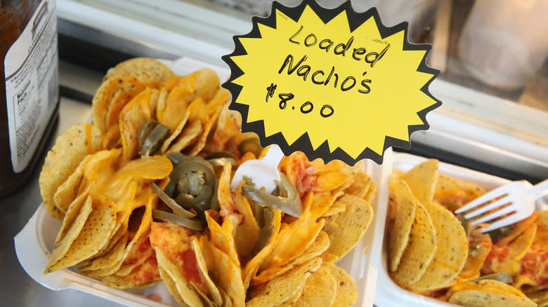 Loaded nachos with sign