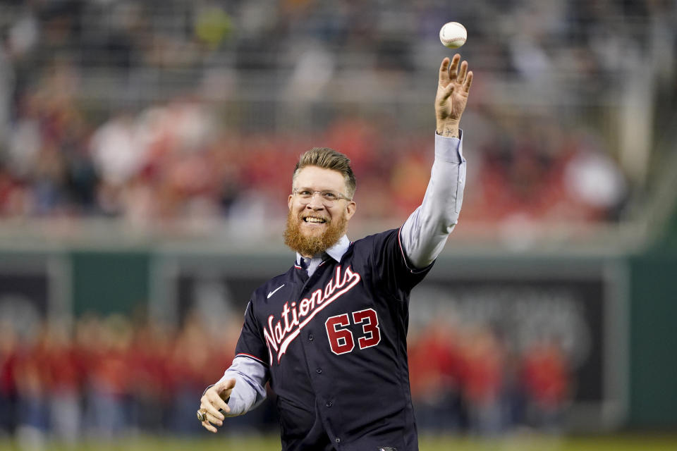 Washington Nationals relief pitcher Sean Doolittle throws out a ceremonial first pitch after announcing his retirement before a baseball game between the Atlanta Braves and the Nationals at Nationals Park, Friday, Sept. 22, 2023, in Washington. Doolittle has decided to retire from baseball after more than a decade pitching in the majors that included helping the Nationals win the World Series in 2019. (AP Photo/Andrew Harnik)