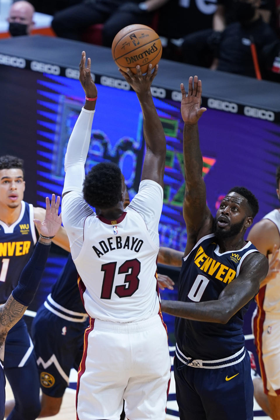 Miami Heat center Bam Adebayo (13) aims for a basket as Denver Nuggets forward JaMychal Green (0) defends during the first half of an NBA basketball game, Wednesday, Jan. 27, 2021, in Miami. (AP Photo/Marta Lavandier)