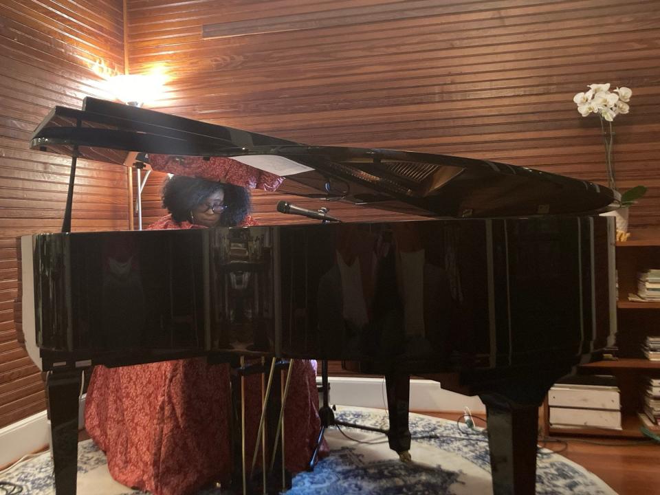 Lilli Lewis, at home, at the piano.