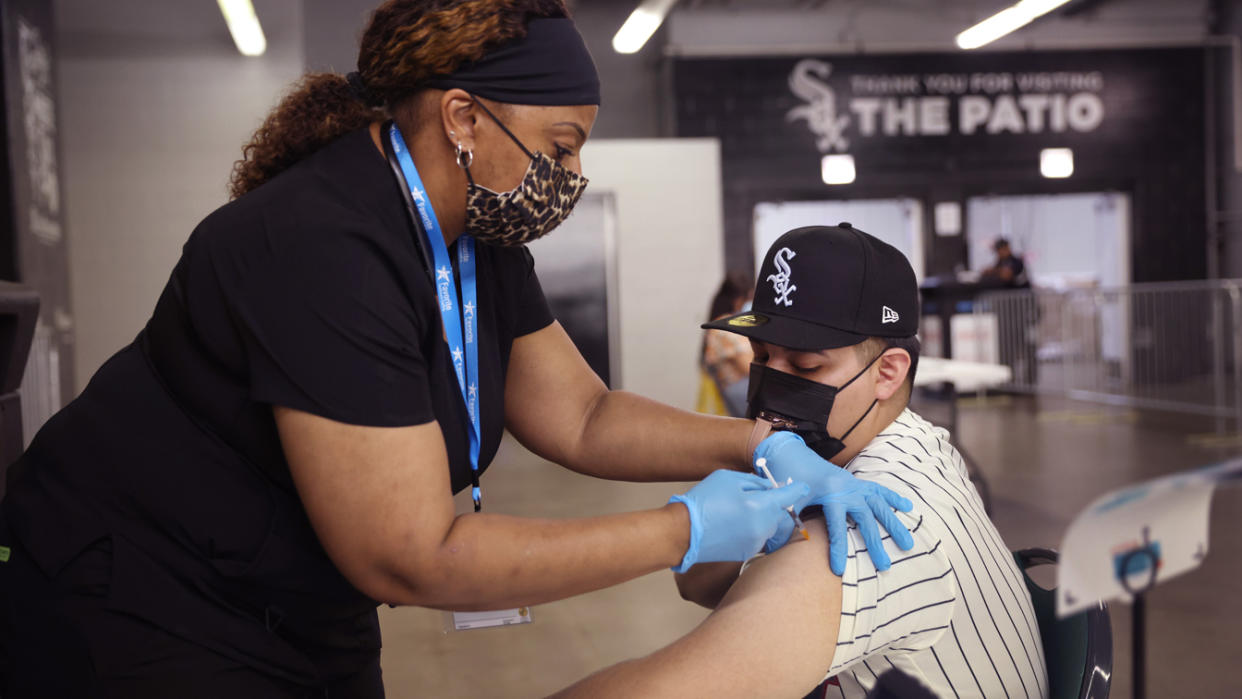 Adam Rodriguez gets a COVID-19 vaccine from Alexis Watts at Guaranteed Rate Field before the start of the Chicago White Sox game against the Toronto Blue Jays on June 08, 2021 in Chicago, Illinois. (Scott Olson/Getty Images)