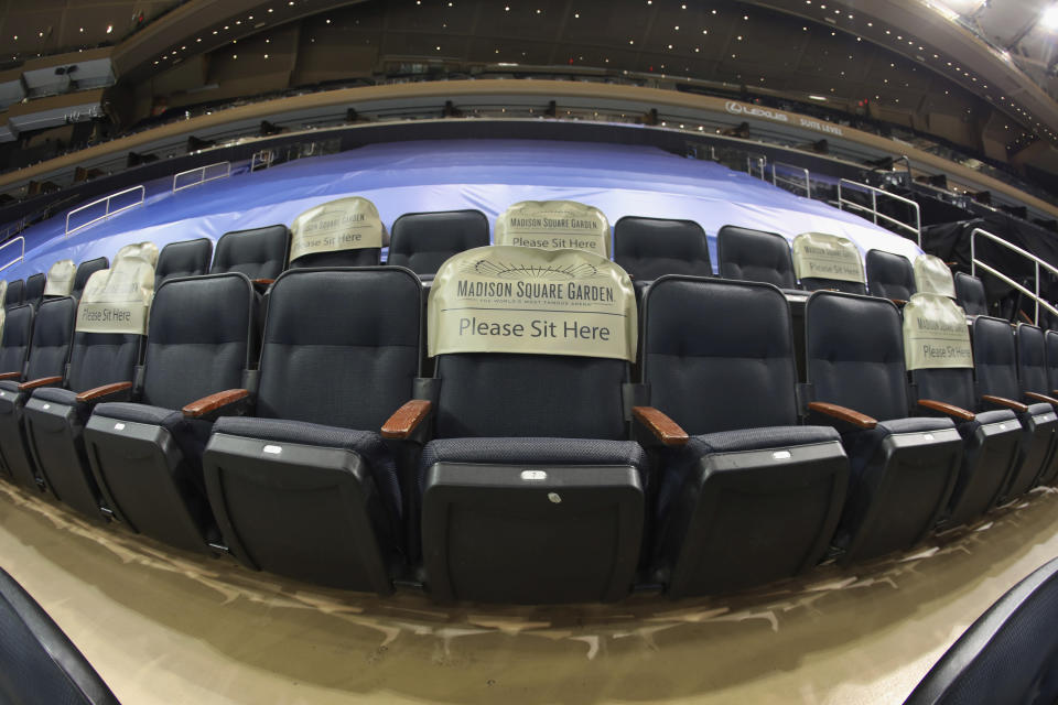 Seats are earmarked for fans at future games prior to the NHL hockey game between the New York Rangers and the Boston Bruins at Madison Square Garden Wednesday, Feb. 10, 2021, in New York. New York State announced today that arenas can re-open on Feb. 23 at 10% occupancy. (Bruce Bennett/Pool Photo via AP)