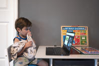 Logan Strauss, 5, participates in an online class from home in Basking Ridge, N.J., Wednesday, July 28, 2021. Logan's parents are keeping him out of school until he gets the COVID-19 vaccine. (AP Photo/Mark Lennihan)