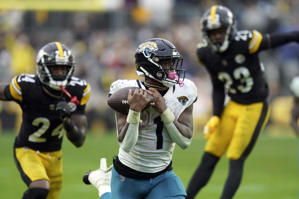 Jacksonville Jaguars running back Travis Etienne Jr. (1) beats Pittsburgh Steelers cornerback Joey Porter Jr. (24) and safety Damontae Kazee (23) on a 56-yard touchdown reception during the second half of an NFL football game Sunday, Oct. 29, 2023, in Pittsburgh. (AP Photo/Matt Freed)