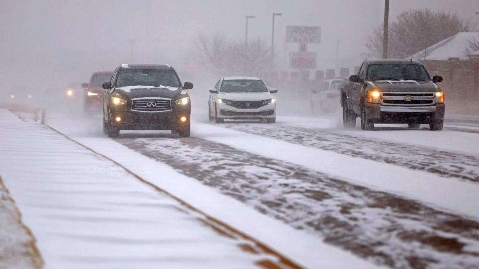 PHOTO: Vehicles drive along N Pennsylvania Avenue as snow falls during a winter storm in Oklahoma City, Okla., Jan. 14, 2024. (Bryan Terry/the Oklahoman via USA Today Network)