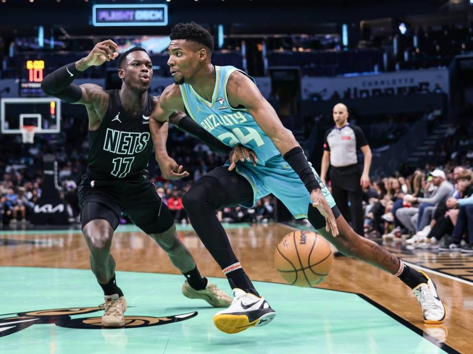 Charlotte Hornets forward Brandon Miller, right, drives past Brooklyn Nets guard Dennis Schroder at the Spectrum Center in Charlotte, N.C., on Saturday, March 9, 2024.