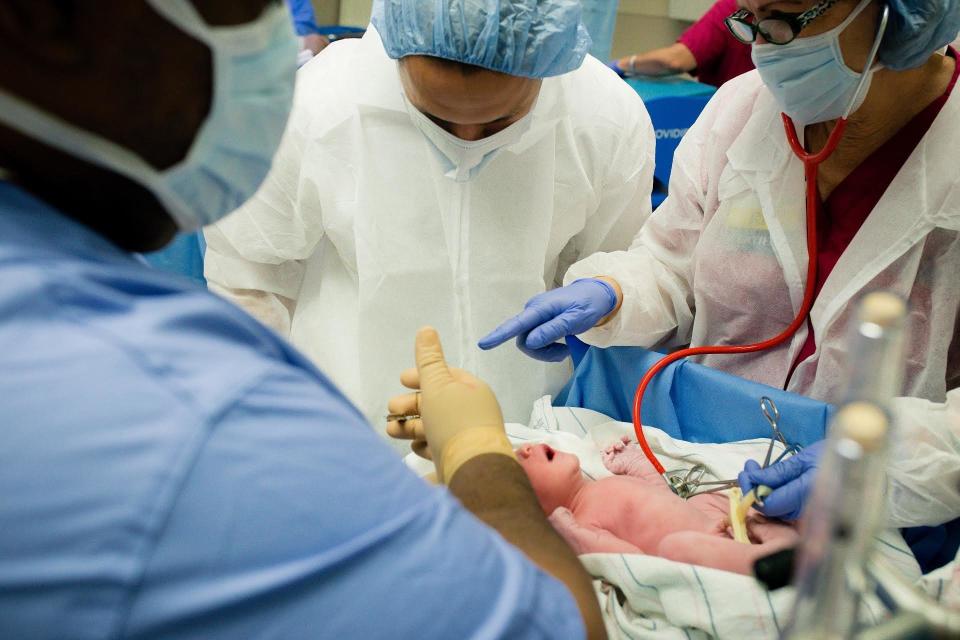 "After a C-section, this nurse helped this stunned dad understand that it was time for him to take the scissors and cut the cord."