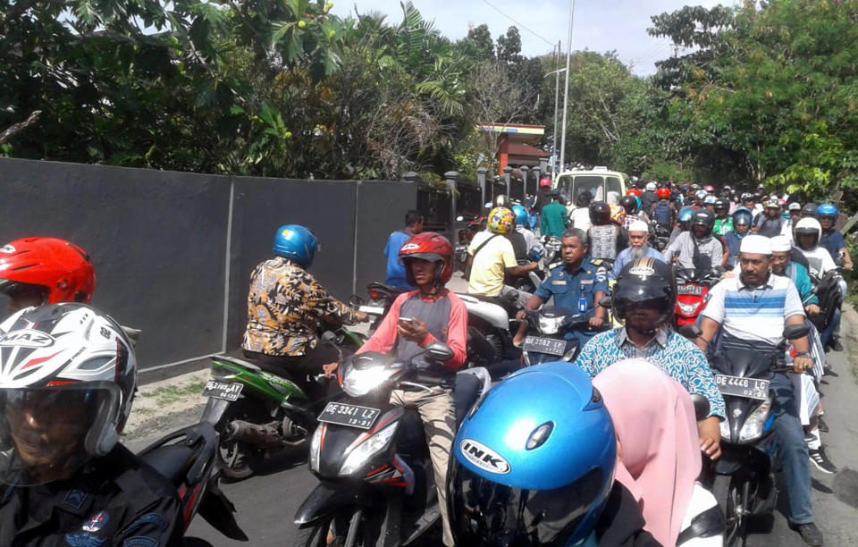 Motorists are seen stuck in traffic as they rush to higher ground following an earthquake in Ambon, Maluku province, Indonesia, Thursday, Sept. 26, 2019. A strong inland earthquake has struck eastern Indonesia Thursday, causing people to flee to higher ground in panic. There were no immediate reports of major damage or casualties. (AP Photo)