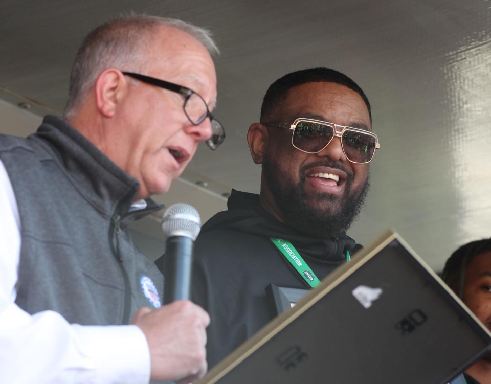 Akron mayor Dan Horrigan reads a proclamation as Buchtel head coach Rayshon Dent listens during the Akron Parade of Champions to celebrate the city's two state basketball champs, Sunday, March 26, 2023.