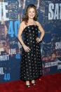 Actress Ana Gasteyer sticks with basic black but the midi hemline and print make it stand out from the rest of the black dresses of the night.
