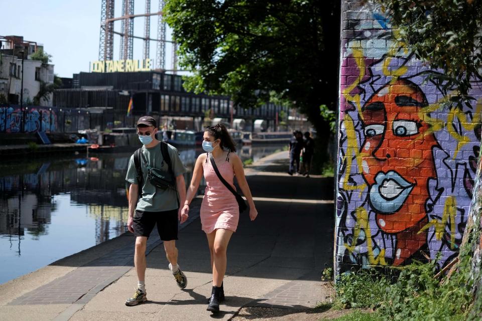 People wearing face masks in London (REUTERS)