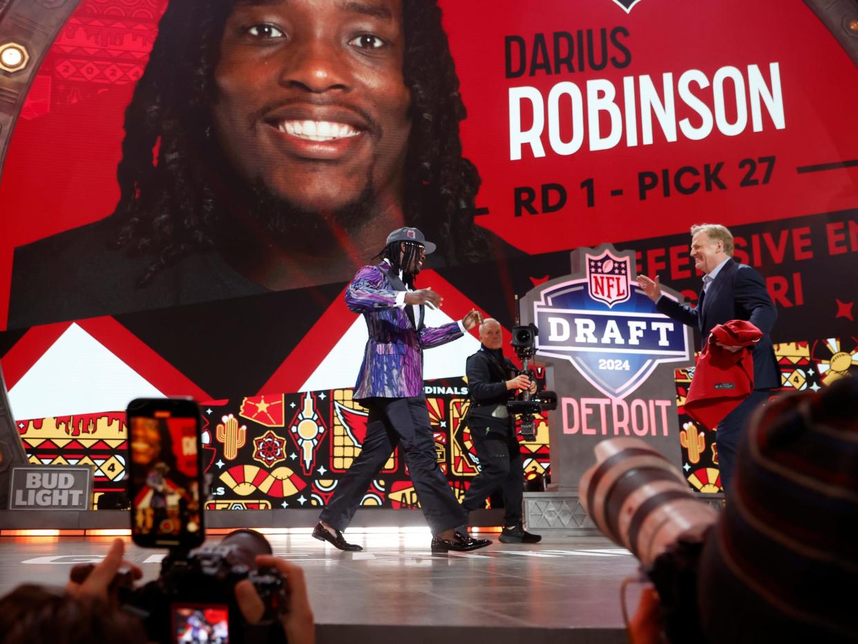 Missouri defensive lineman Darius Robinson greets NFL commissioner Roger Goodell and shows off his Arizona Cardinals jersey after he was picked in the first round of the 2024 NFL draft at the NFL draft theater in Detroit on Thursday, April 25, 2024.