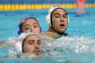 United States' Johnny Hooper, right, plays against Japan during a preliminary round men's water polo match at the 2020 Summer Olympics, Sunday, July 25, 2021, in Tokyo, Japan. Hooper is half Japanese. His mother is from Japan, and his grandmother still lives in the country, but neither of them can be in attendance because of COVID-19. (AP Photo/Mark Humphrey)