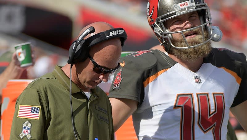 In this Nov. 11, 2018, file photo, then-Tampa Bay Buccaneers quarterbacks coach Mike Bajakian, left, works with quarterback Ryan Fitzpatrick on the sideline during the first half of an NFL football game against the Washington Redskins in Tampa, Fla.