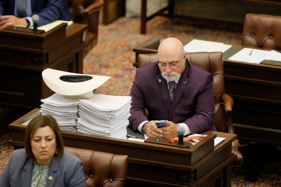 Sen. Blake Stephens, R-Tahlequah, looks at his phone May 27, during the final day of the legislative session at the state Capitol in Oklahoma City.