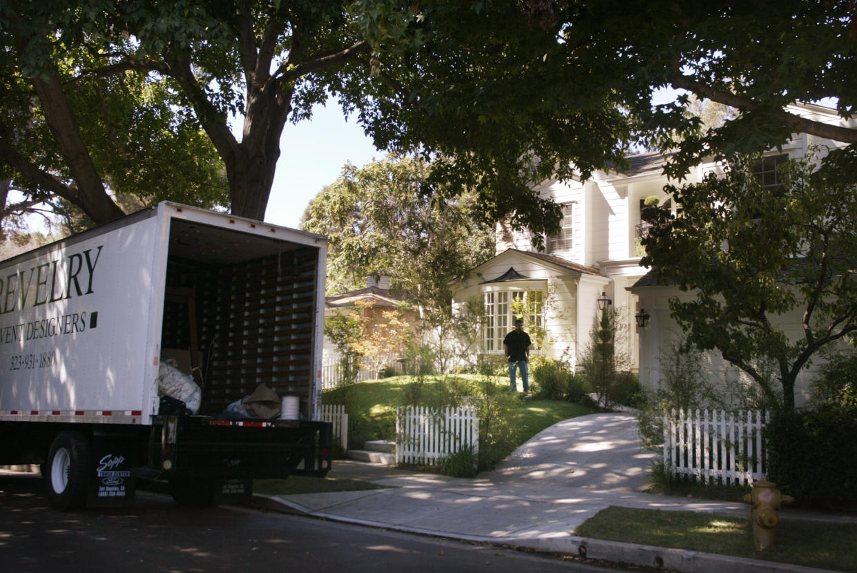 A security guard stands in the front yard of the house in Studio City, California where pop singer Britney Spear married her new husband Kevin Federline September 18, 2004 in a surprise nighttime ceremony with family and twenty to thirty guests is shown in the morning September 20, 2004. A truck from a special events company is shown which was sent to pickup a tent used at the event. REUTERS/Fred Prouser  FSP