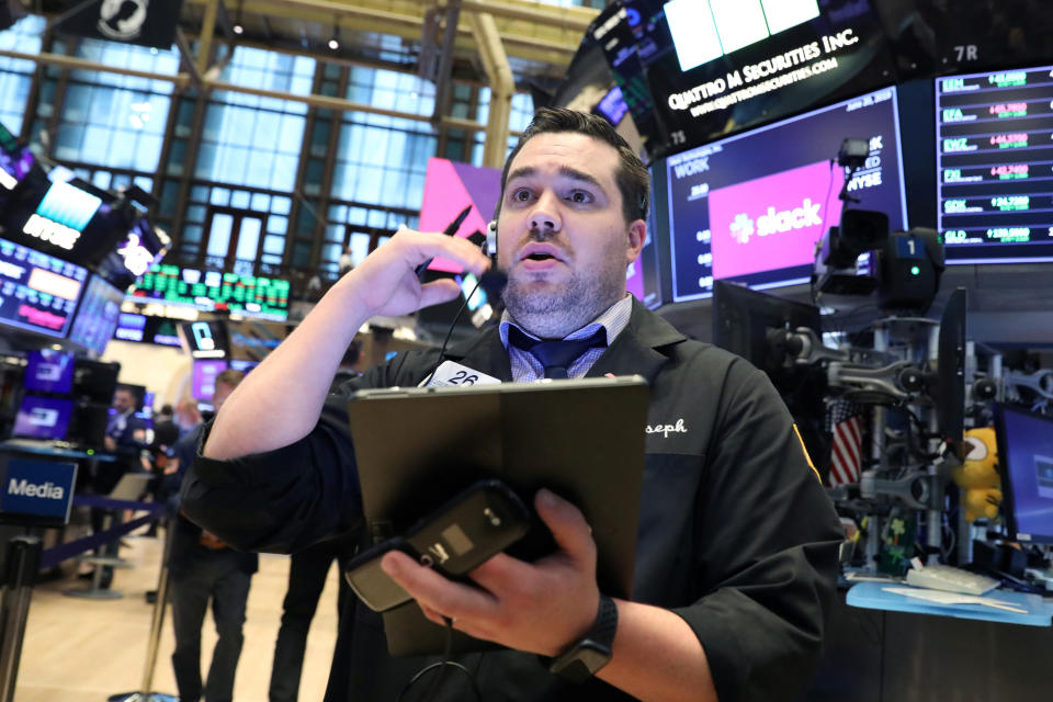 A trader works on the floor during the Slack Technologies Inc. IPO at the New York Stock Exchange (NYSE) in New York, U.S. June 20, 2019.  REUTERS/Brendan McDermid