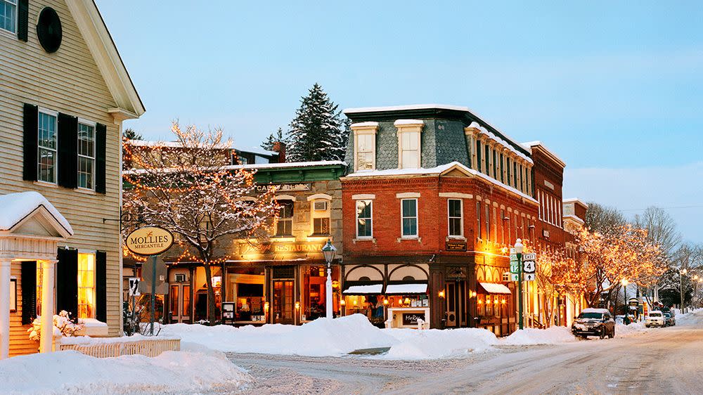 a street with buildings and snow in woodstock vermont