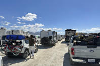 Vehicles line up in a several hour wait to leave the Burning Man festival in Black Rock Desert, Nev., Tuesday, Sept. 5, 2023. The traffic jam leaving the festival eased up considerably Tuesday as the exodus from the mud-caked Nevada desert entered a second day following massive rain that left tens of thousands of partygoers stranded there for days. (AP Photo/Andy Barron)