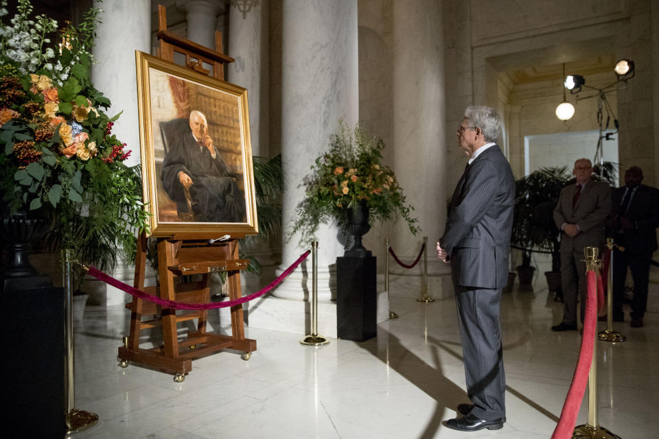 Former President Barack Obama's Supreme Court nominee Merrick Garland stops at a painting of the late Supreme Court Justice John Paul Stevens while paying his respects as Stevens lies in repose in the Great Hall of the Supreme Court in Washington, Monday, July 22, 2019. (AP Photo/Andrew Harnik)