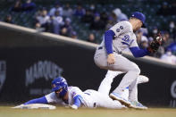 Chicago Cubs' Kris Bryant, left, slides safely into second for a double off Los Angeles Dodgers starting pitcher Trevor Bauer as shortstop Corey Seager looks to apply a late tag during the third inning of a baseball game Tuesday, May 4, 2021, in Chicago. (AP Photo/Charles Rex Arbogast)